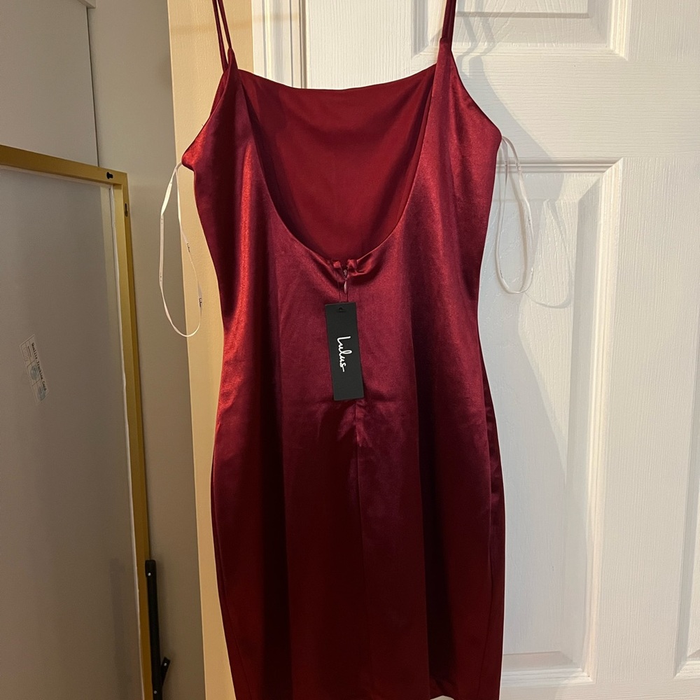 Silky red low back mini dress. New with tag. Size medium. Smoke free, pet free.